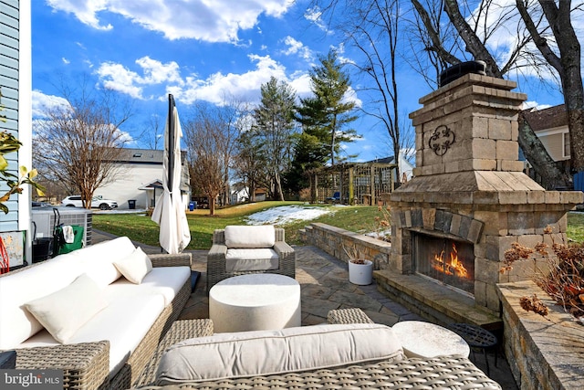 view of patio featuring an outdoor living space with a fireplace