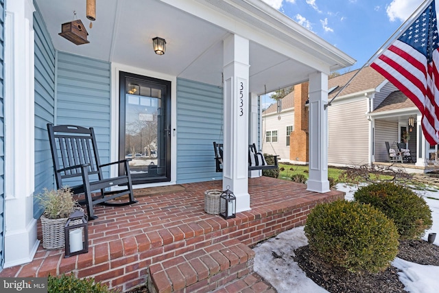 view of exterior entry featuring a porch