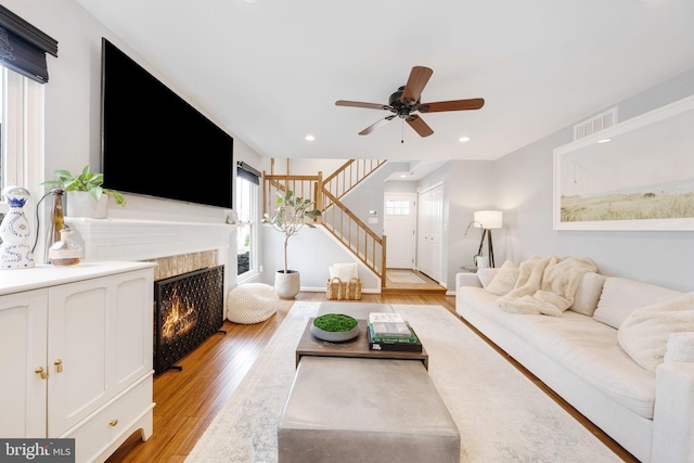 living room with ceiling fan and light wood-type flooring