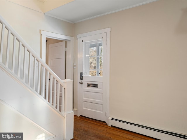 entrance foyer with crown molding, a baseboard heating unit, and dark wood-type flooring