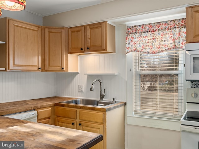 kitchen with crown molding, sink, white appliances, and wooden counters