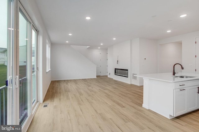 35666 Aspen Way, Locust Grove, VA 22508 - unfurnished living room featuring a sink, light wood-style floors, recessed lighting, and baseboards