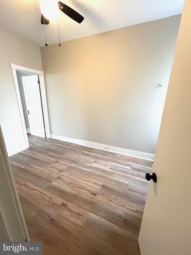 unfurnished room with hardwood / wood-style flooring and ceiling fan