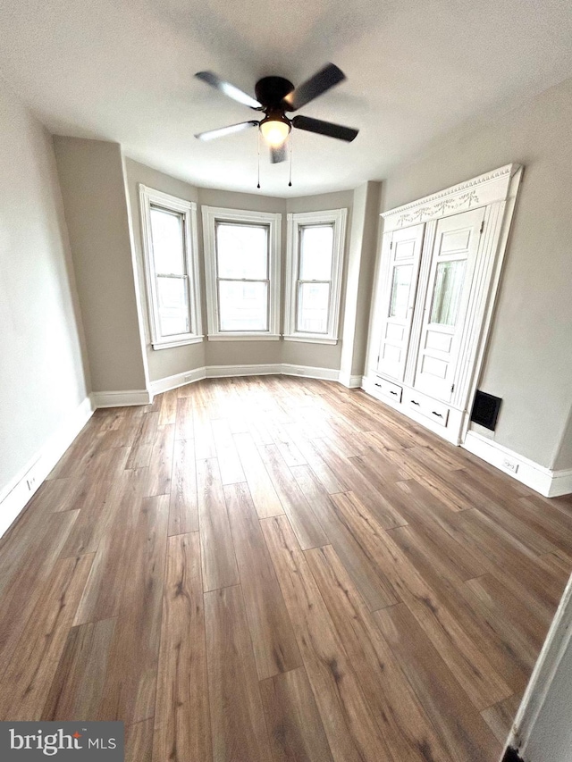 unfurnished bedroom with hardwood / wood-style floors, a textured ceiling, and ceiling fan