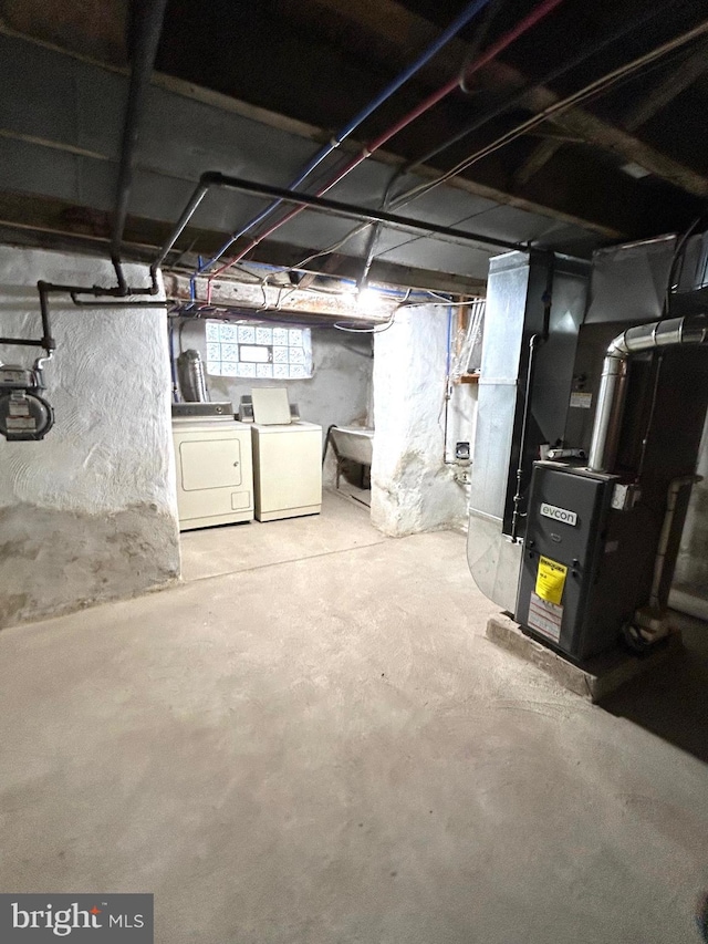 basement with heating unit and washer and dryer