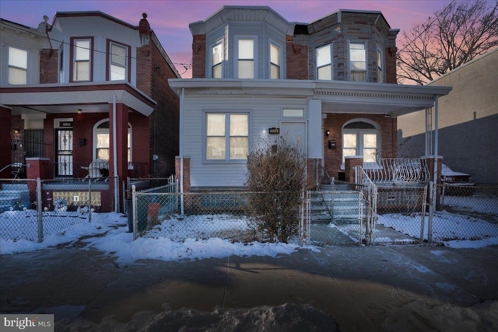 townhome / multi-family property with covered porch