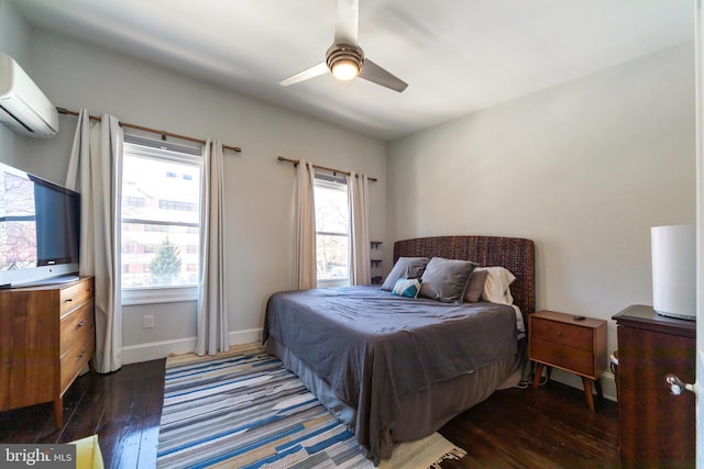 bedroom with multiple windows, an AC wall unit, dark hardwood / wood-style floors, and ceiling fan