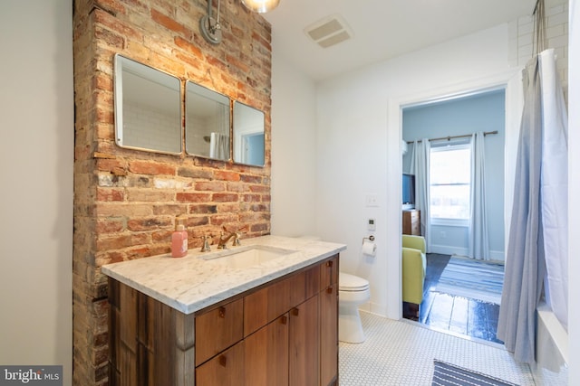 full bathroom featuring vanity, shower / bath combo, and toilet