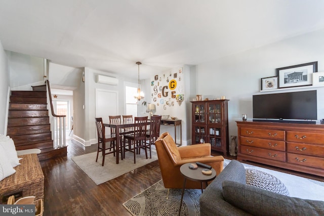 living room featuring dark hardwood / wood-style floors and an AC wall unit