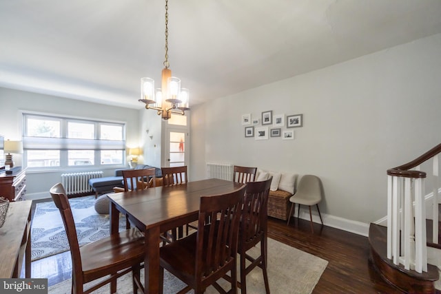 dining room with radiator, an inviting chandelier, and dark hardwood / wood-style floors