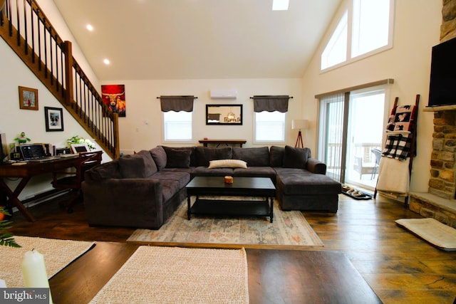 living room with high vaulted ceiling, a wall mounted AC, and dark hardwood / wood-style flooring