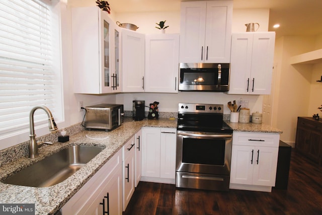 kitchen featuring sink, white cabinets, and appliances with stainless steel finishes