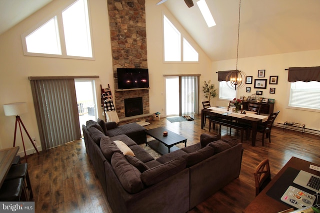 living room with a fireplace, dark hardwood / wood-style floors, a chandelier, and high vaulted ceiling