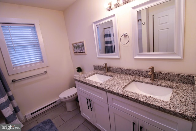 bathroom featuring vanity, tile patterned floors, baseboard heating, and toilet