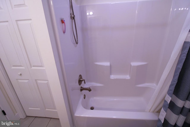 bathroom featuring tile patterned flooring and shower / bath combo