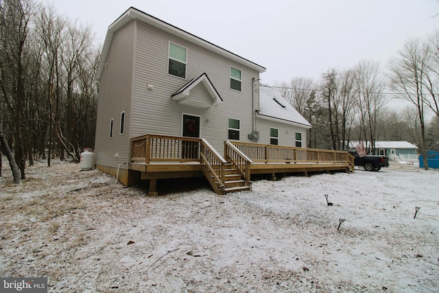 rear view of house with a wooden deck