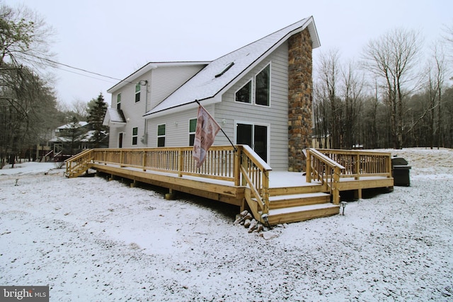 snow covered property with a wooden deck