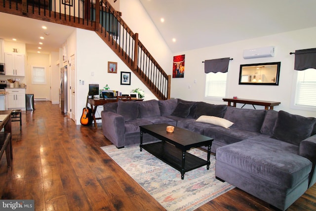 living room with dark wood-type flooring, a baseboard radiator, a wall mounted AC, and a high ceiling