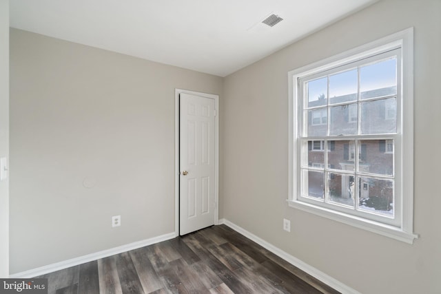 spare room with dark hardwood / wood-style floors