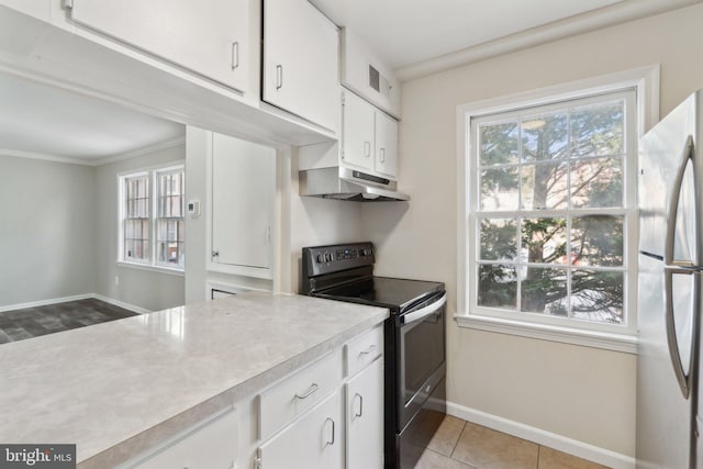 kitchen featuring light tile patterned floors, crown molding, stainless steel appliances, and white cabinets