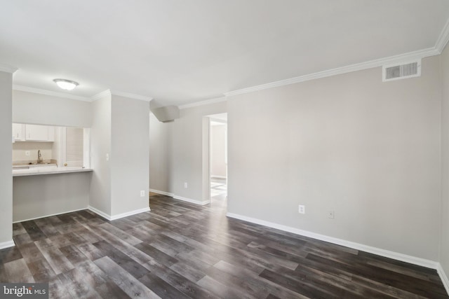 unfurnished living room featuring dark hardwood / wood-style flooring and ornamental molding