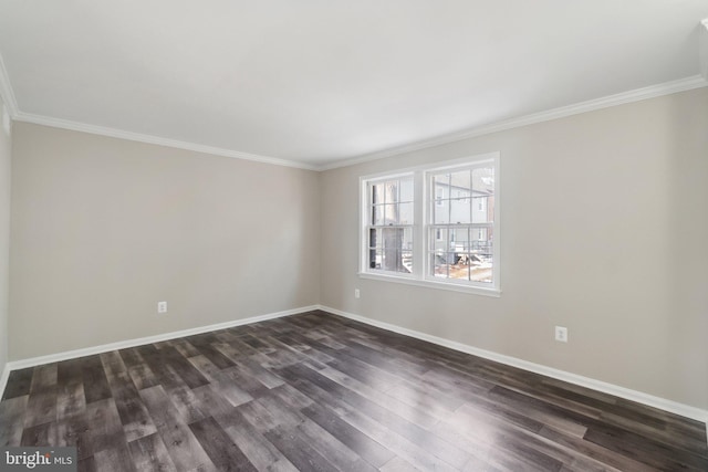 empty room featuring dark wood-type flooring and ornamental molding