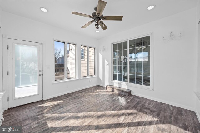 unfurnished sunroom with ceiling fan