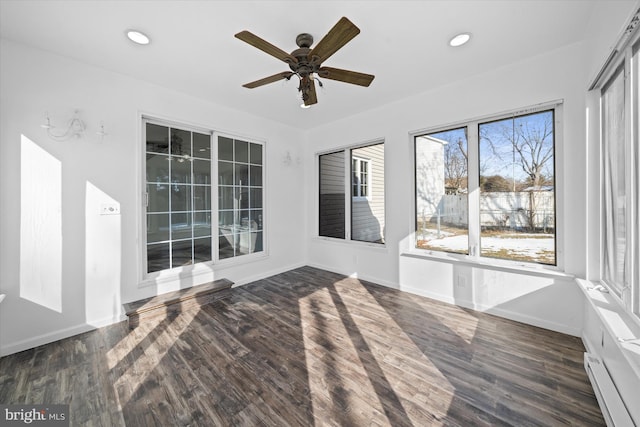 unfurnished sunroom with a baseboard heating unit and ceiling fan