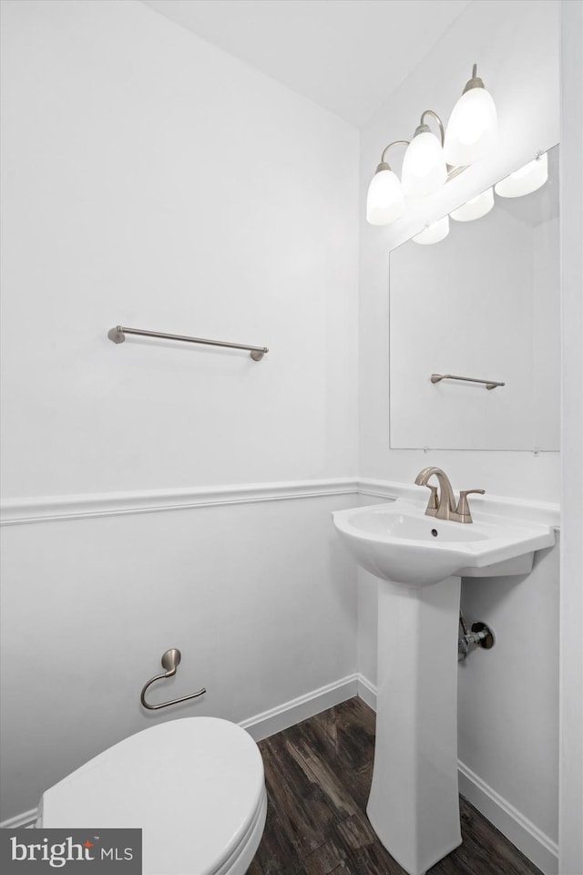 bathroom with wood-type flooring and toilet