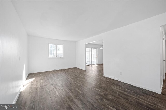 spare room featuring dark wood-type flooring