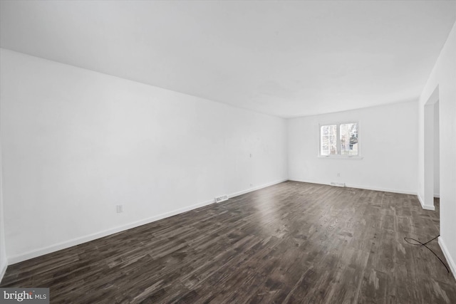 spare room with dark hardwood / wood-style flooring