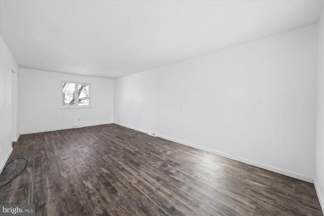 unfurnished room featuring dark hardwood / wood-style floors