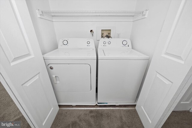 clothes washing area featuring washer and dryer and dark colored carpet