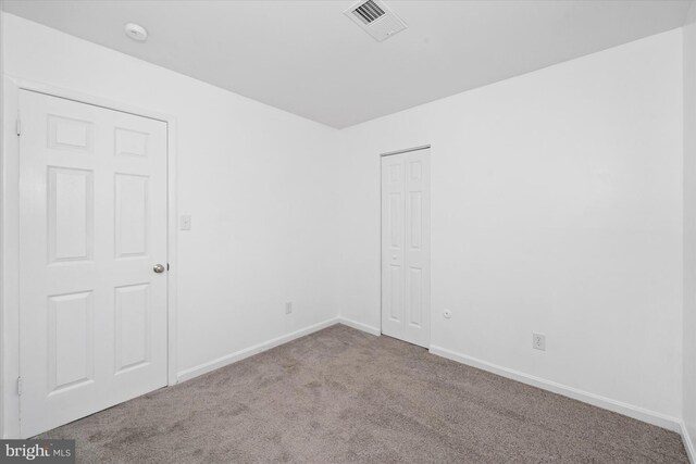 unfurnished room with light colored carpet