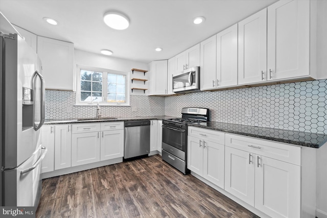 kitchen featuring sink, stainless steel appliances, white cabinets, dark hardwood / wood-style flooring, and decorative backsplash