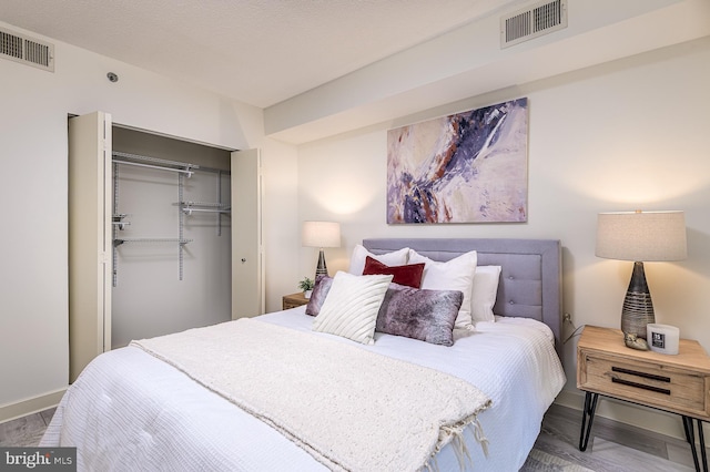 bedroom with a textured ceiling and a closet