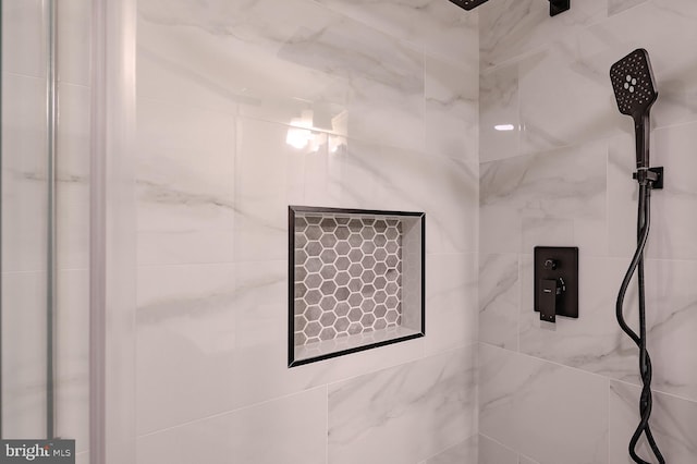 interior details featuring a tile shower