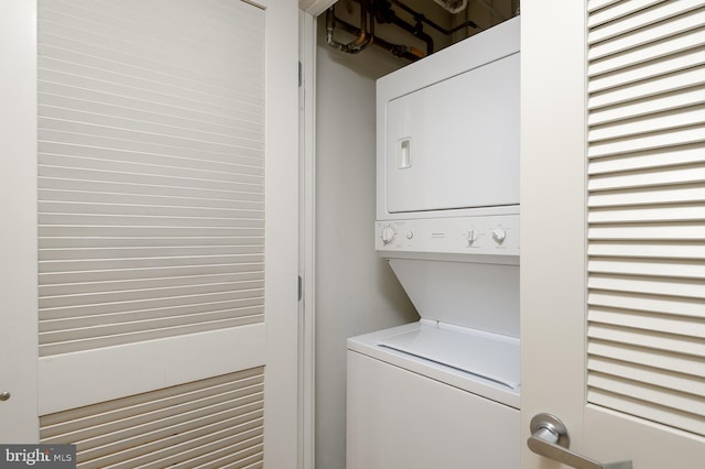 laundry room featuring stacked washer and dryer