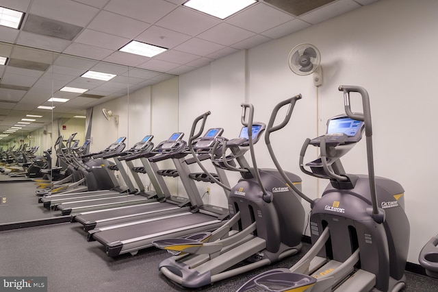 workout area with a paneled ceiling