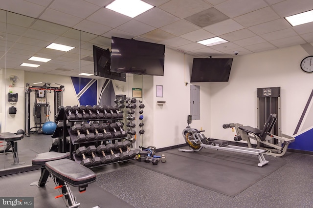 workout area featuring a paneled ceiling and electric panel