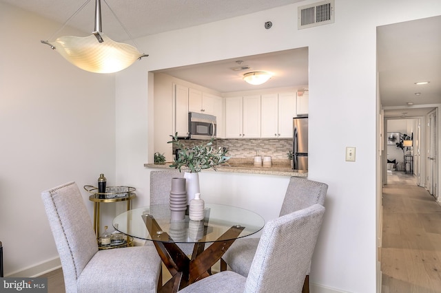 dining room with hardwood / wood-style flooring