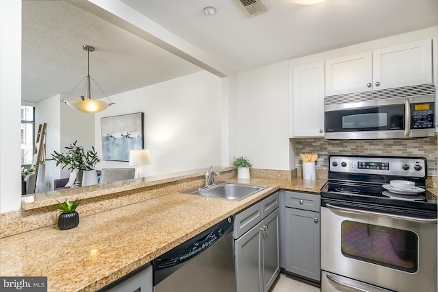 kitchen featuring gray cabinets, pendant lighting, sink, white cabinets, and stainless steel appliances