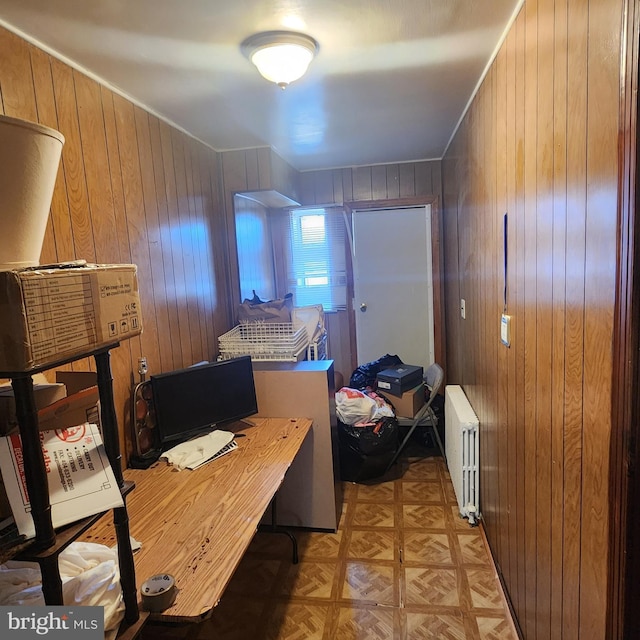 office featuring radiator heating unit, light parquet floors, and wood walls