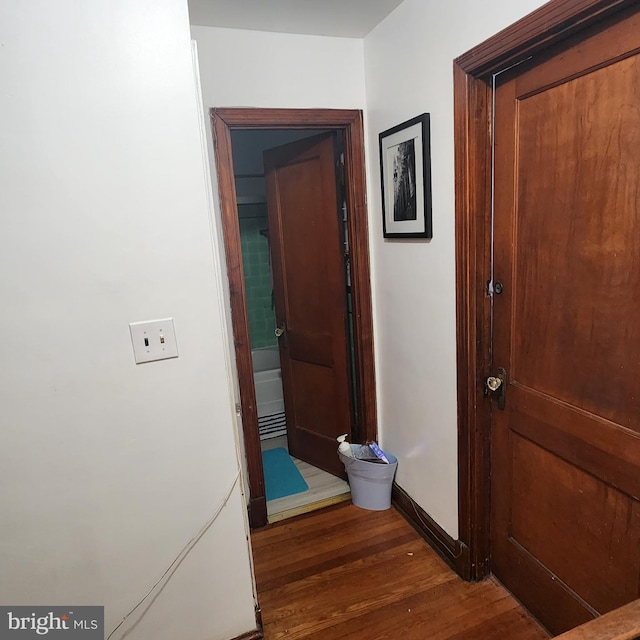 corridor featuring dark wood-type flooring