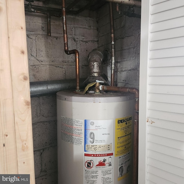 utility room featuring gas water heater