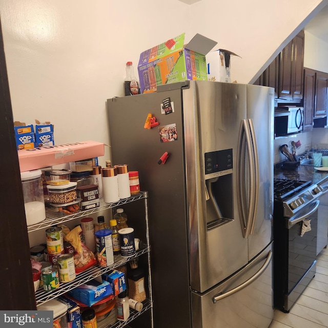 kitchen featuring appliances with stainless steel finishes and dark brown cabinets