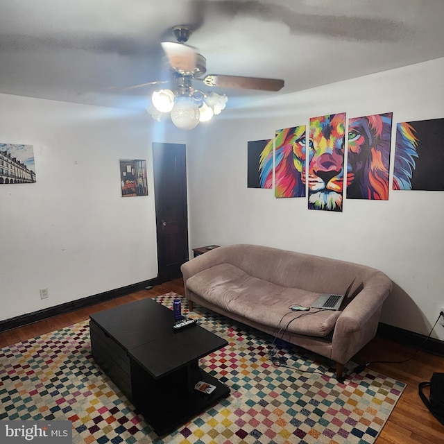 living room featuring ceiling fan and hardwood / wood-style floors