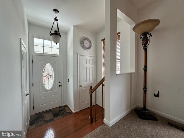 view of carpeted foyer entrance