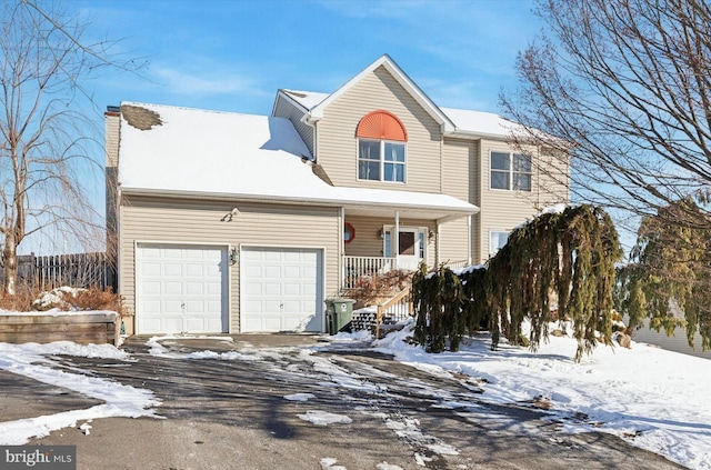 view of front of property with a porch and a garage