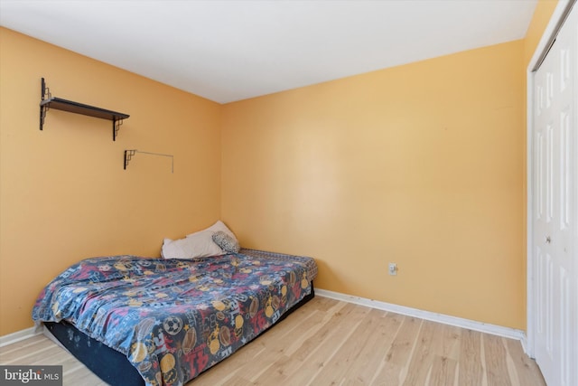 bedroom featuring a closet and light hardwood / wood-style flooring